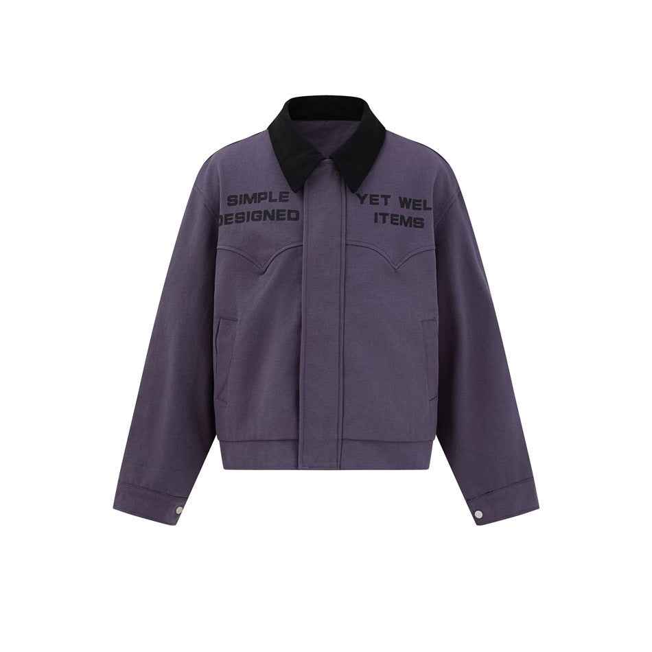 Purple cropped collared jacket with black corduroy-style collar, black chest slogan text, western yoke seams and snap cuffs