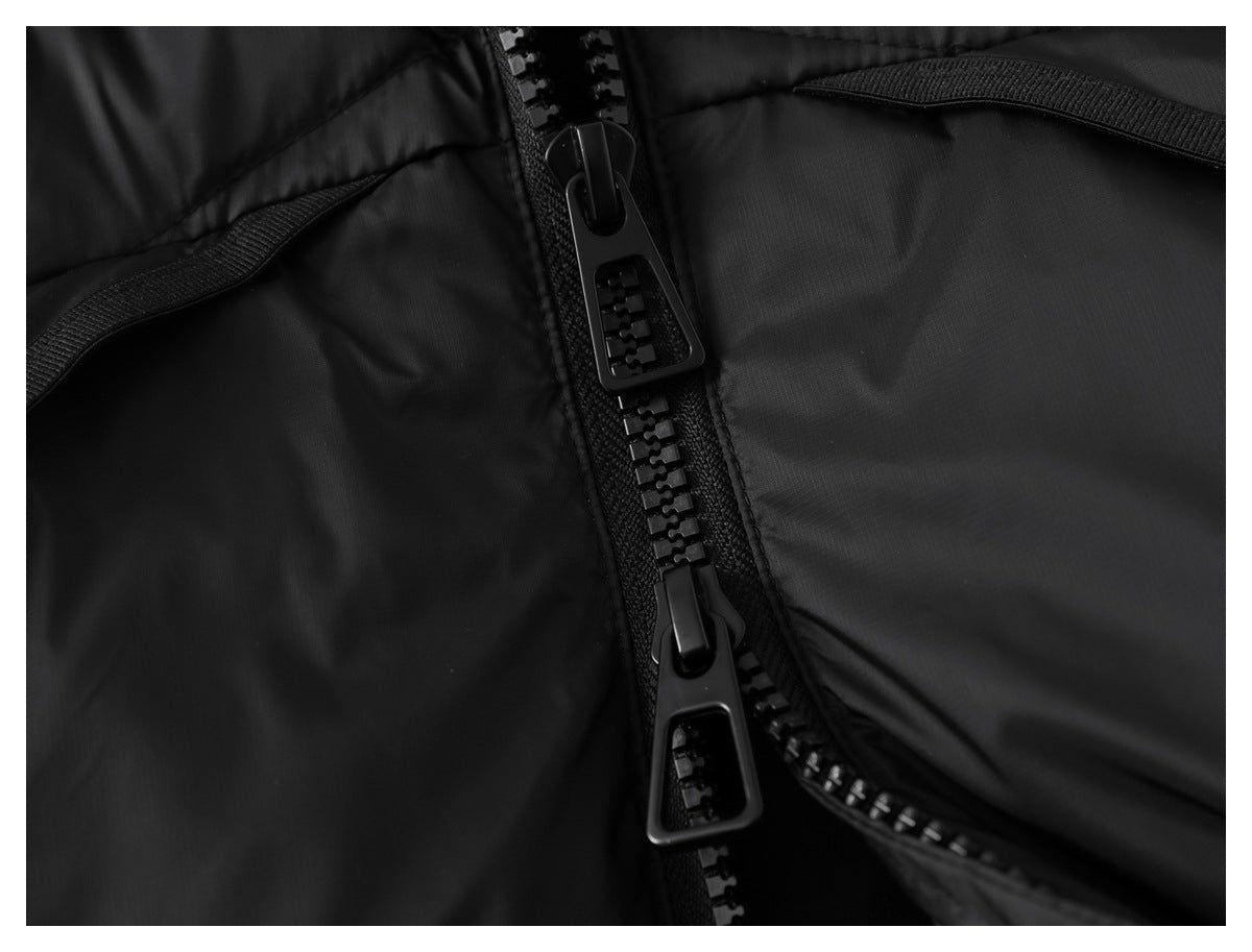 Close-up of a black jacket's two-way front zipper and curved pocket trim.
