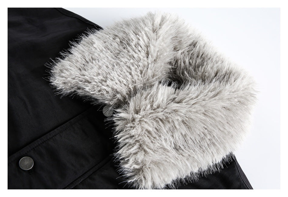 Close-up of the thick gray faux-fur collar on a black coat, with a metal snap visible.