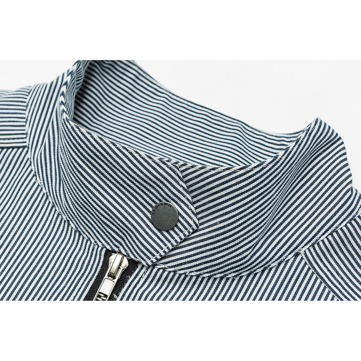 Close-up of a navy-and-white striped jacket collar, snap button and front zipper.