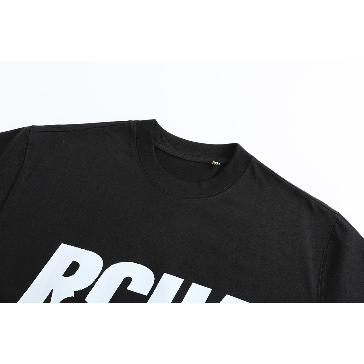 Close-up of a black crew-neck T-shirt showing the collar and part of its large white chest graphic.
