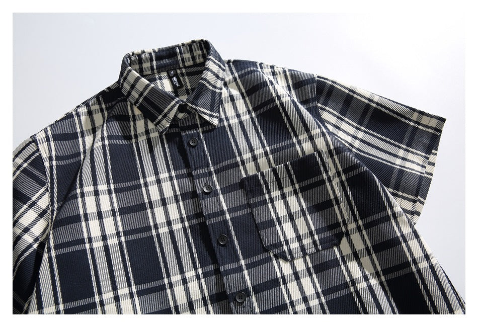 Front view of a navy and white plaid short-sleeve button-up shirt with a chest pocket.