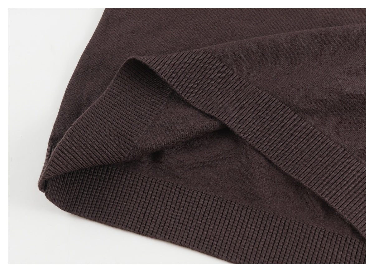 Close-up of the dark brown sweater's wide ribbed hem, folded to show its edge.