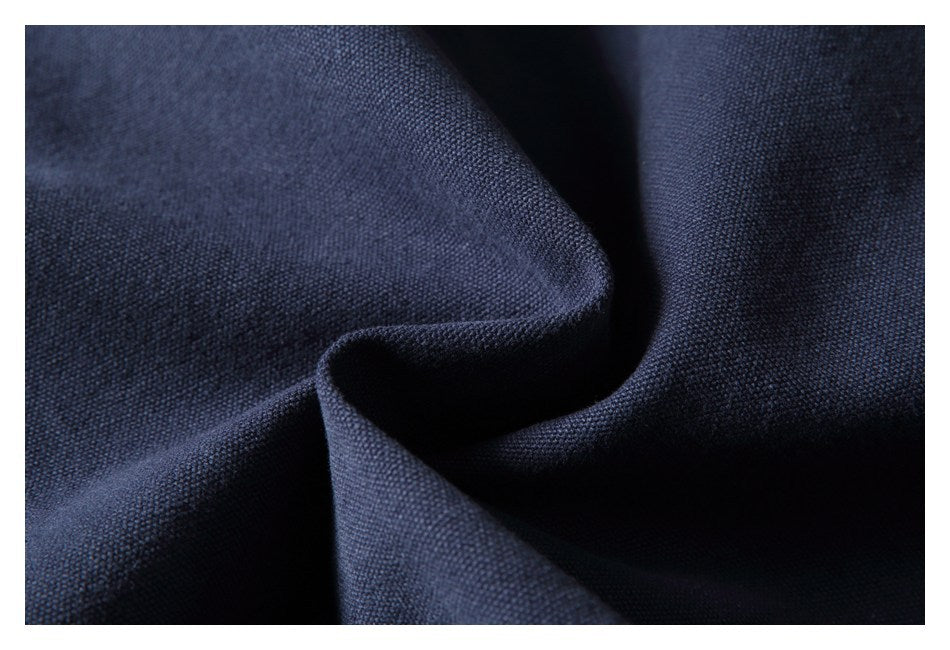 Close-up showing the textured weave and folds of dark navy fabric.