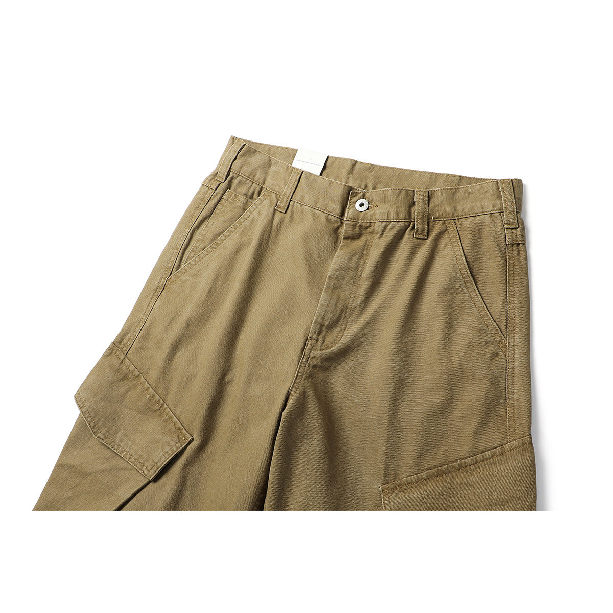 Close-up front view of tan cargo pants with a button waist, belt loops, slanted pockets and flap cargo pockets.
