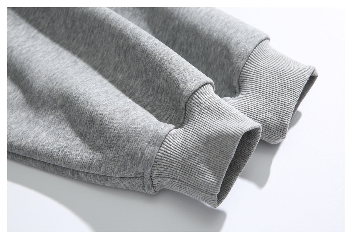 Close-up of two ribbed cuffs on the sleeves of a heather gray sweatshirt.
