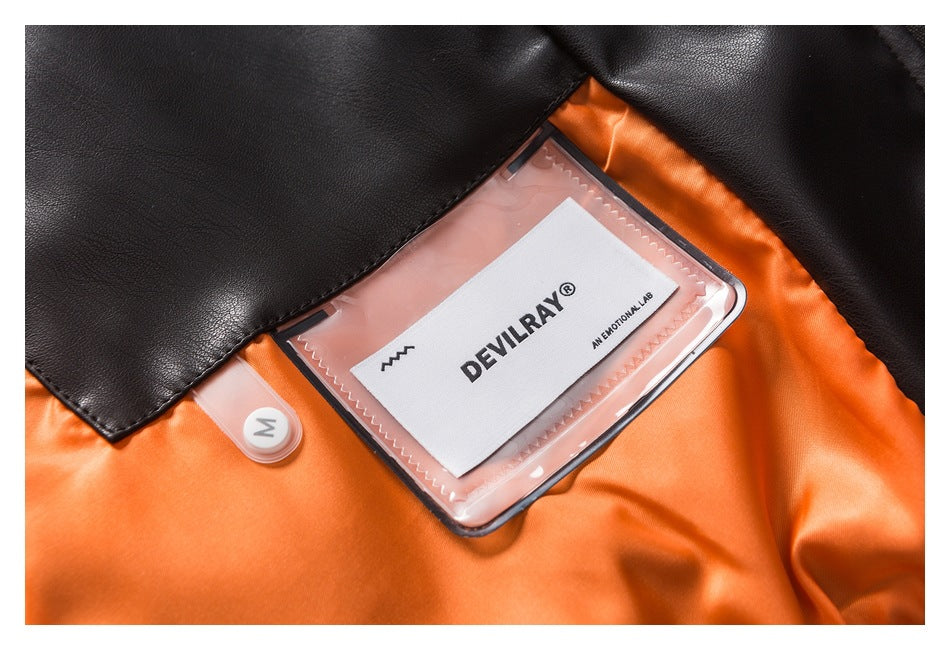 Close-up of an orange and black garment interior with a clear label pocket and a white DEYLRAY label.