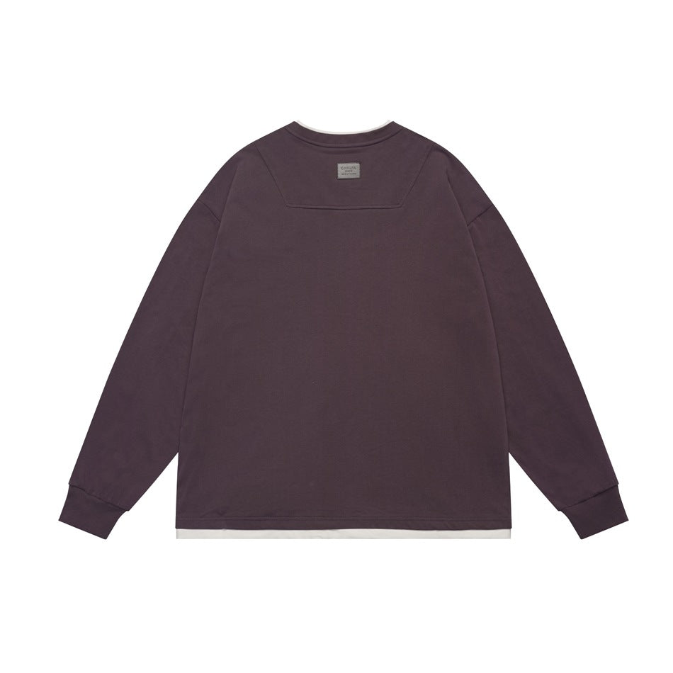 Back view of a muted plum long-sleeve crewneck top with ribbed cuffs and a narrow white layer at the hem.