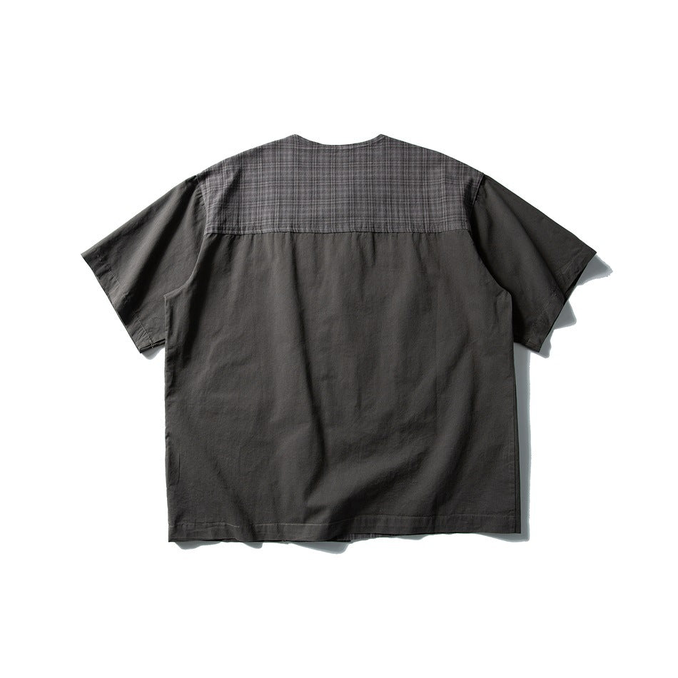 Back view of a charcoal short-sleeve shirt with a checked shoulder yoke.