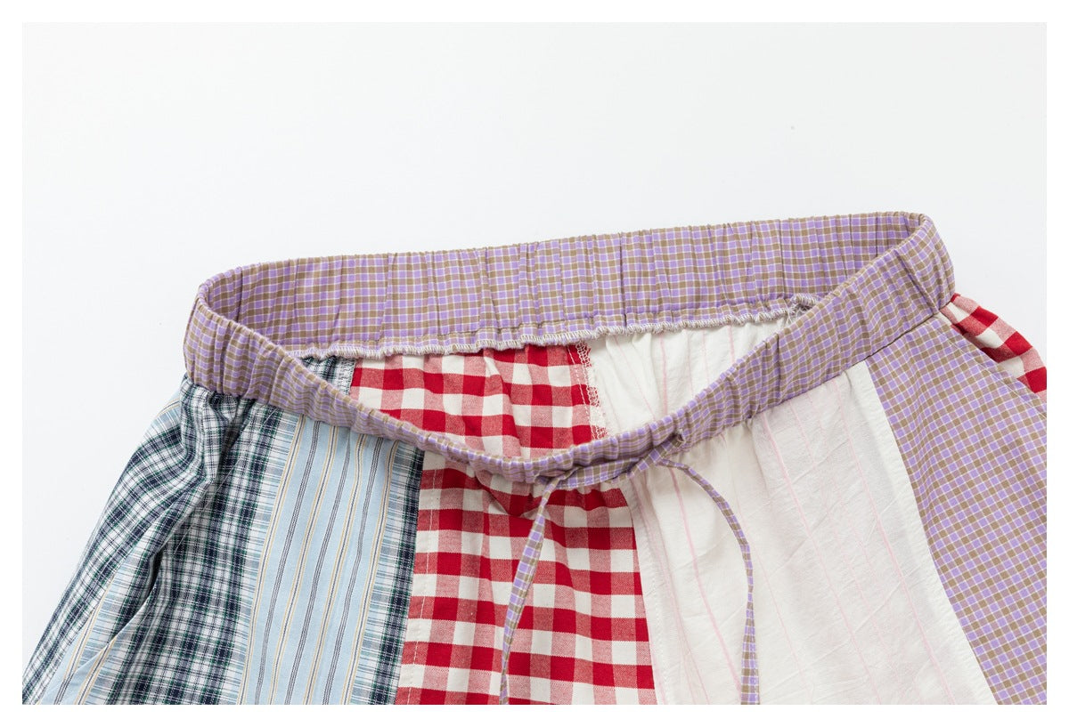 Close-up of the pants' gathered lavender-check waistband and drawstring, with contrasting patchwork panels.