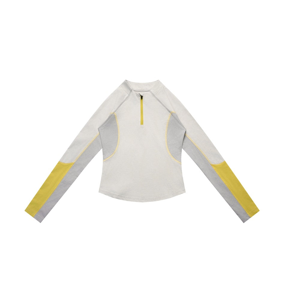 Off-white half-zip long-sleeve top with gray side panels and yellow sleeve ends and zipper, flat lay