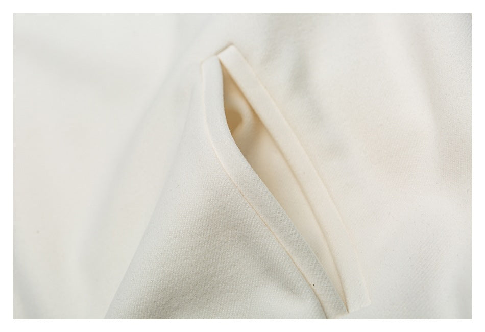 Close-up of a folded seam or edge on ivory fabric.