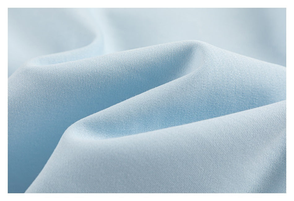 Close-up of pale blue fabric with a fine, tightly woven texture draped in soft folds.
