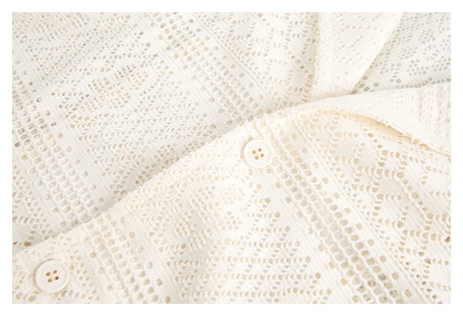 Close-up of the ivory lace shirt's front placket with two matching buttons.
