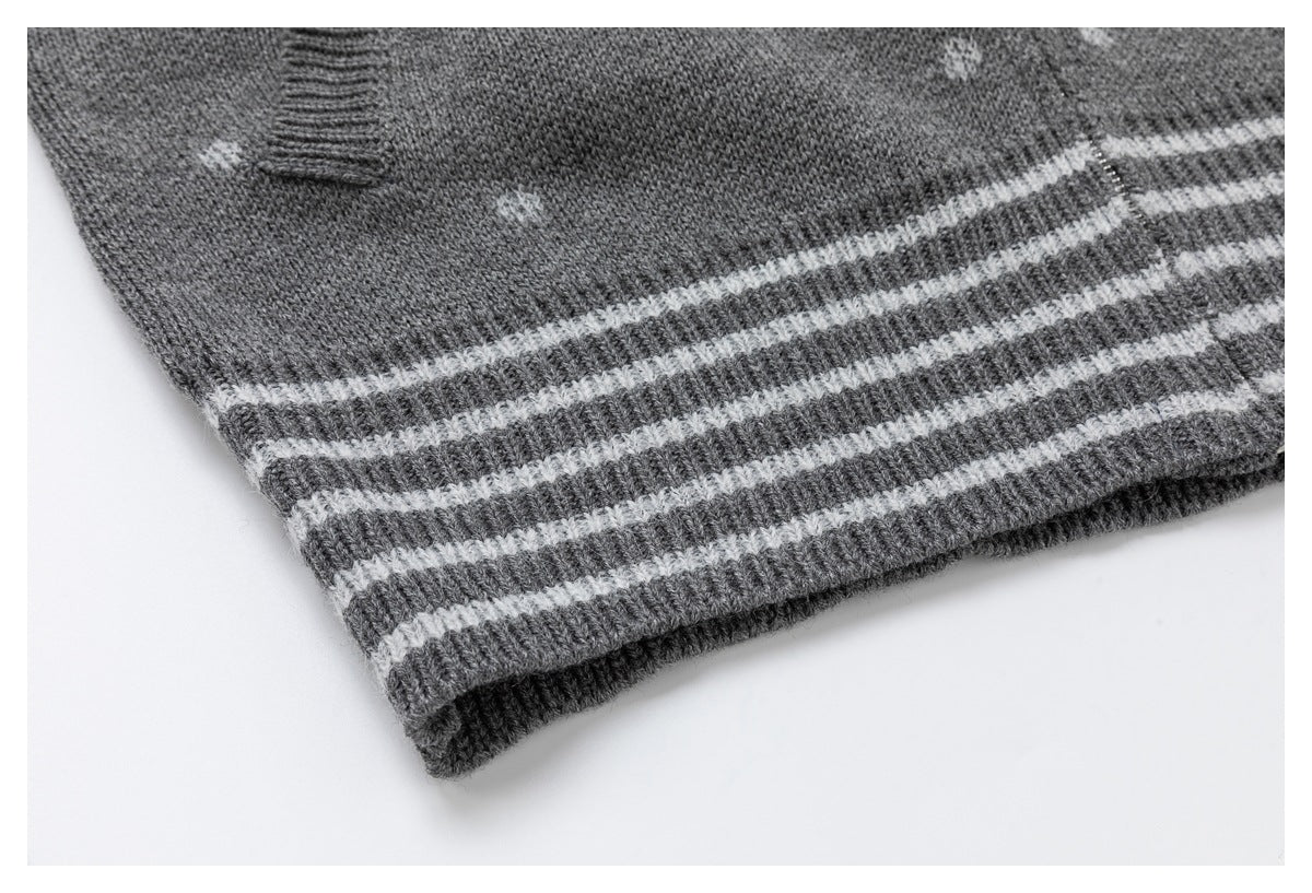 Close-up of the cardigan's gray ribbed hem with several narrow white horizontal stripes.