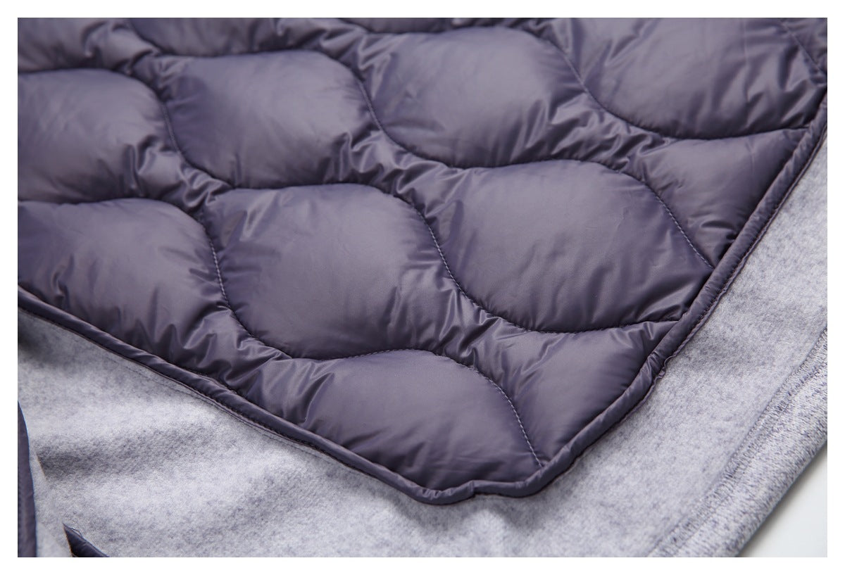 Dark purple quilted lining lies against light gray fabric, with the padded sections and edging visible.