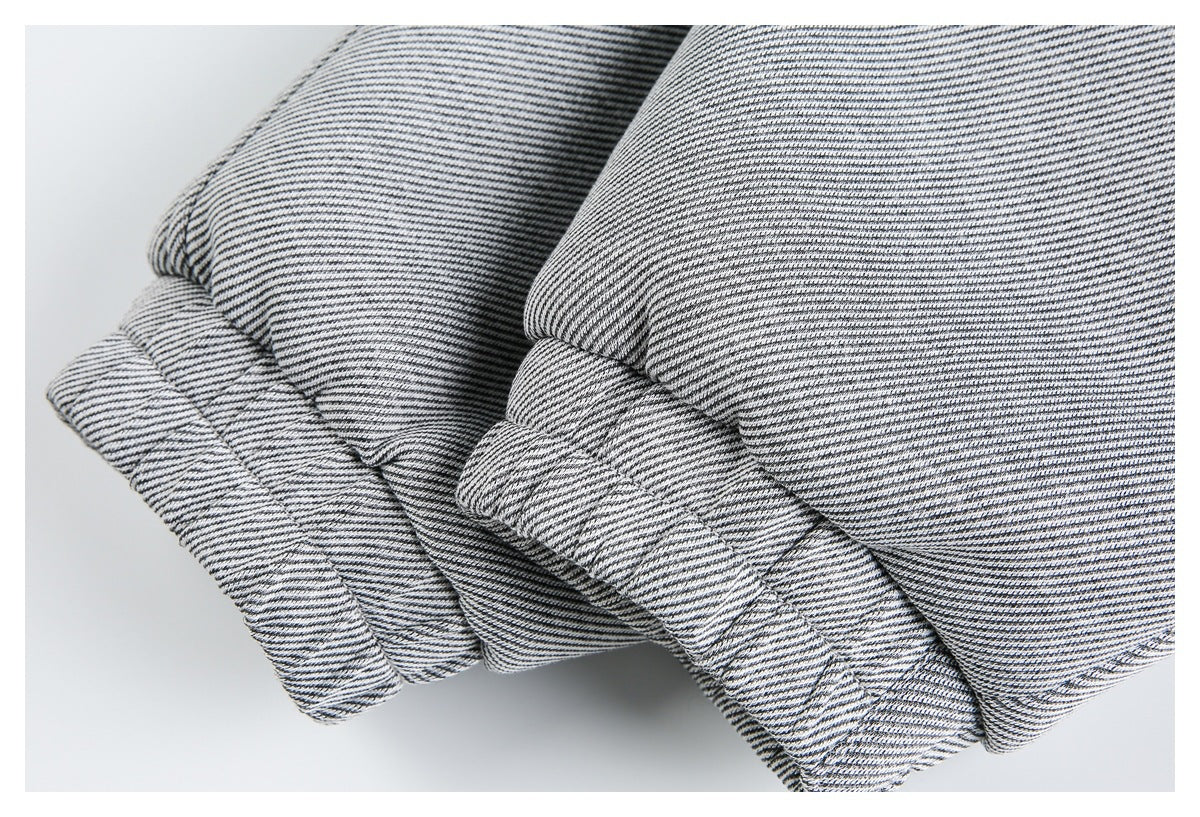 Close-up of folded cuffs or hems on a black-and-white striped garment.