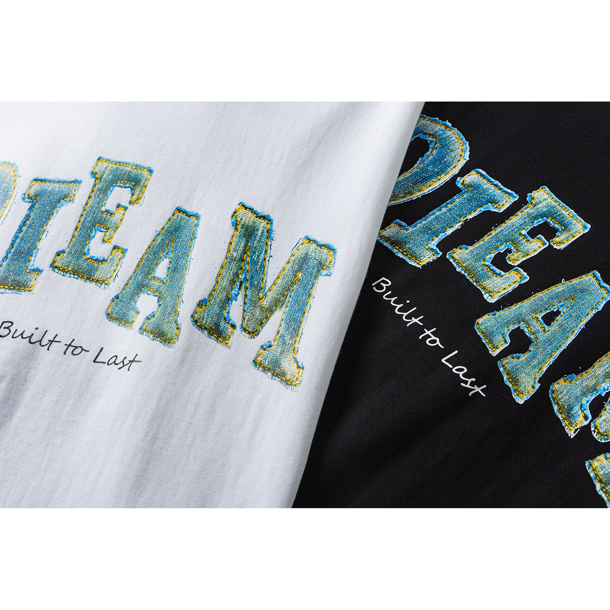 Close-up of white and black T-shirts with blue-and-yellow “DREAM” lettering and “Built to Last” text.