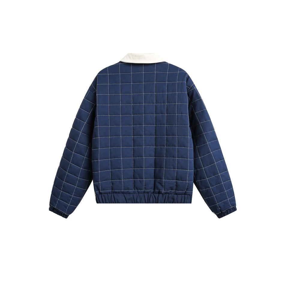 Back view of a navy quilted jacket with white grid stitching and a cream collar.