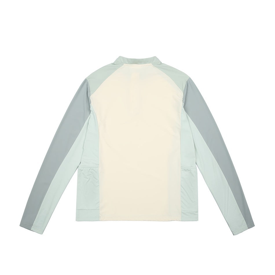 Back view of a long-sleeve top with a cream center panel and pale mint and sage panels.