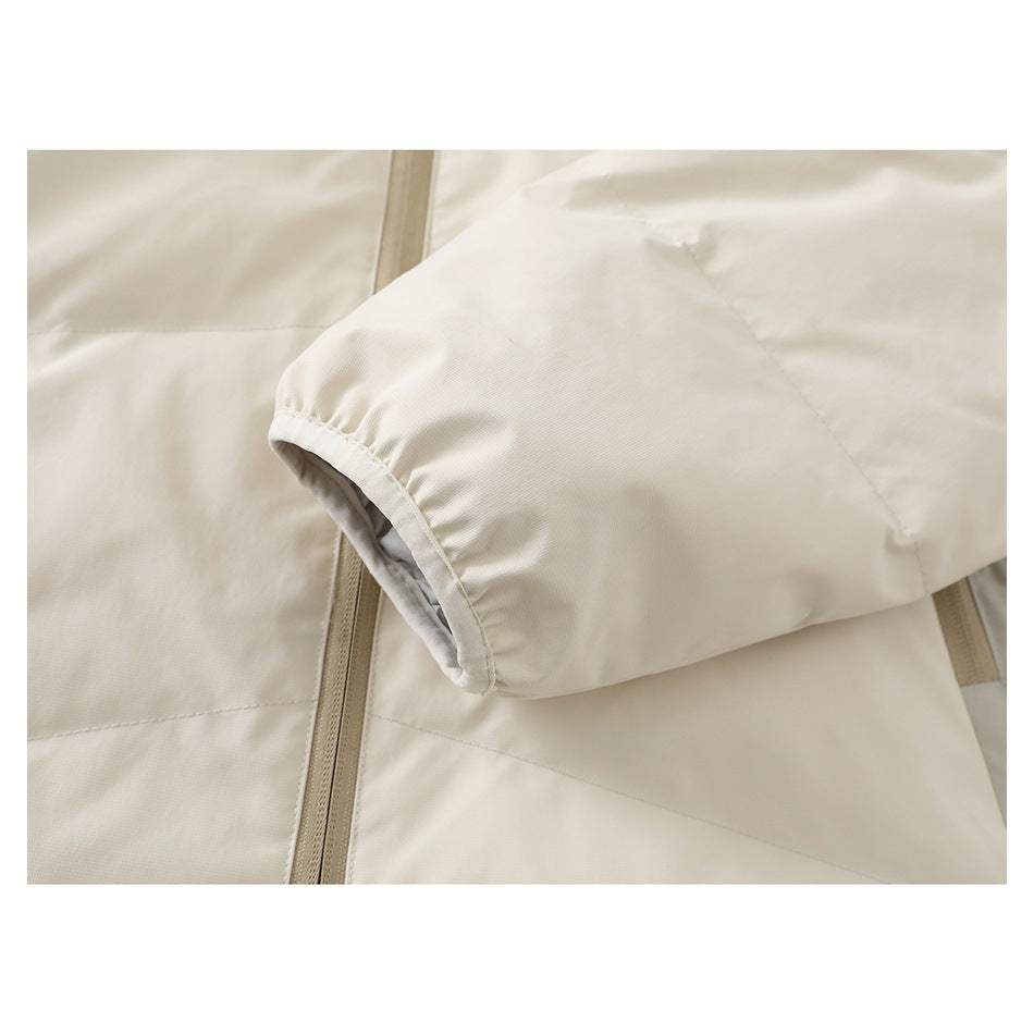Close-up of the ivory jacket's elasticized sleeve cuff, stitching and tan zipper.