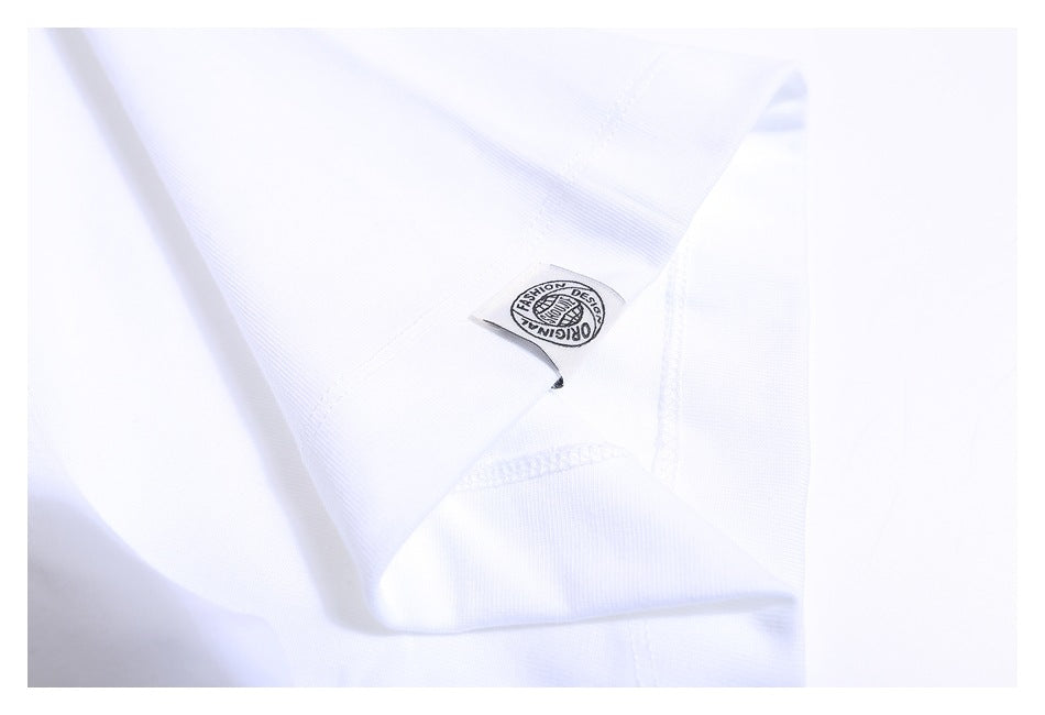 Close-up of a small printed tag and stitching on the white T-shirt.