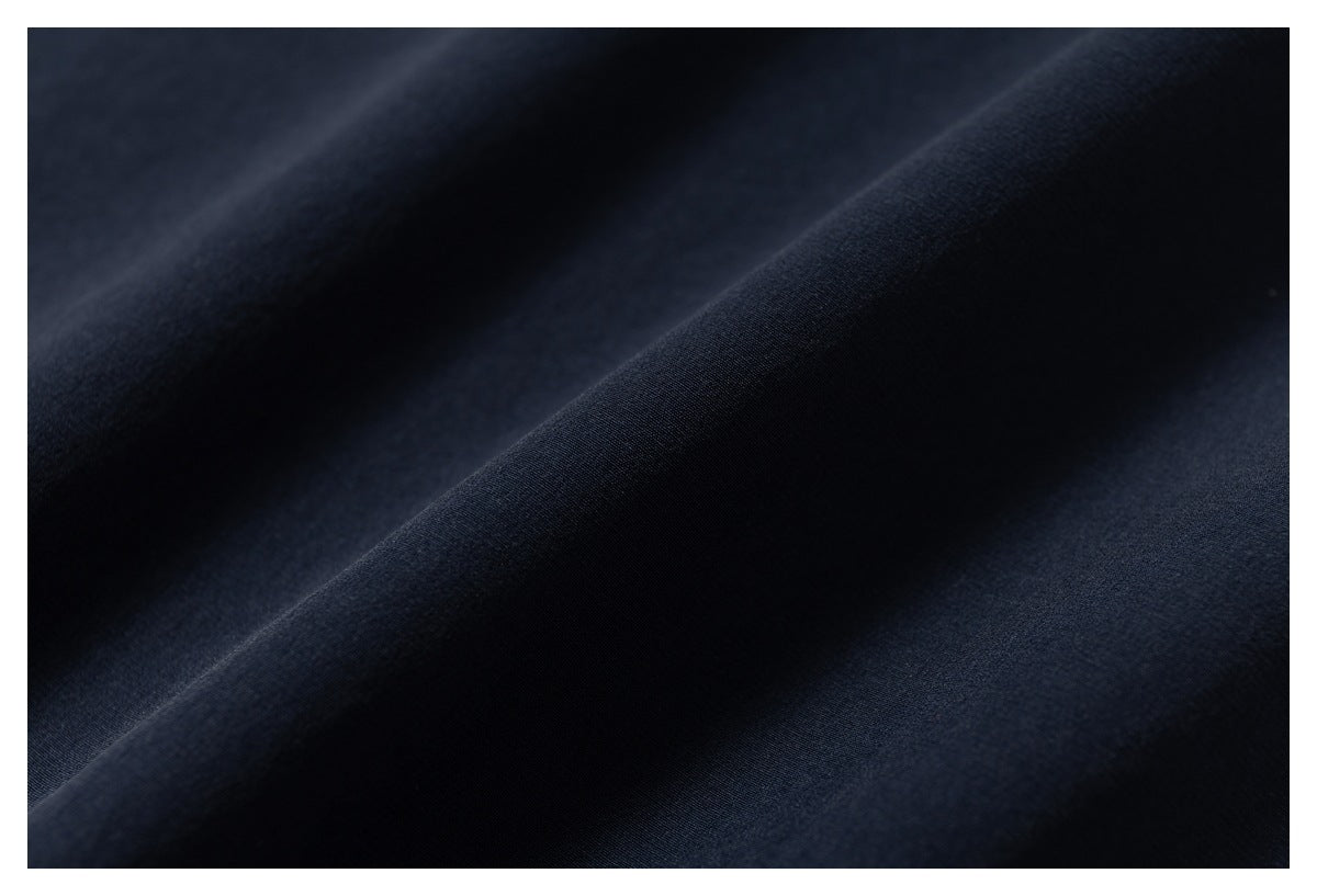 Close-up showing the smooth, dark navy fabric in soft folds.