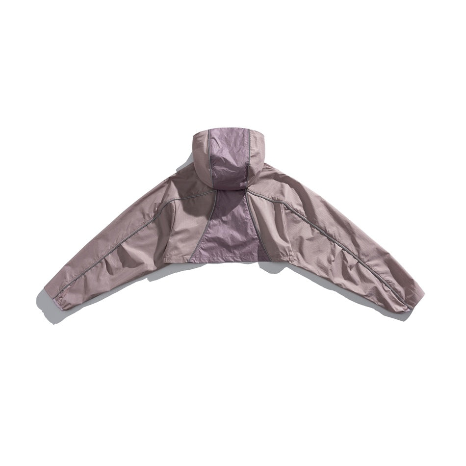 Back view of a dusty mauve hooded cape jacket with wide sleeves and a contrasting center back panel.