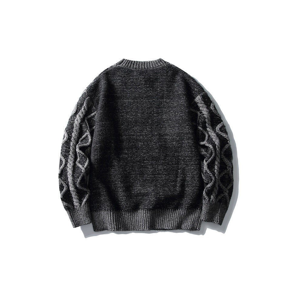 Back view of a charcoal sweater with raised gray cable-knit sleeves and ribbed trim.