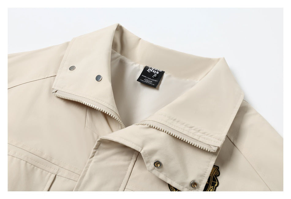 Cream jacket collar with zipper, metal snaps, and a small sewn neck label.