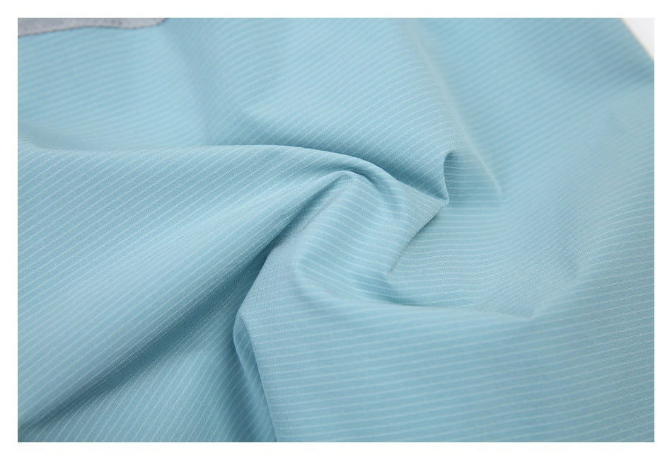 Close-up of light blue fabric with fine, evenly spaced white pinstripes and soft folds.