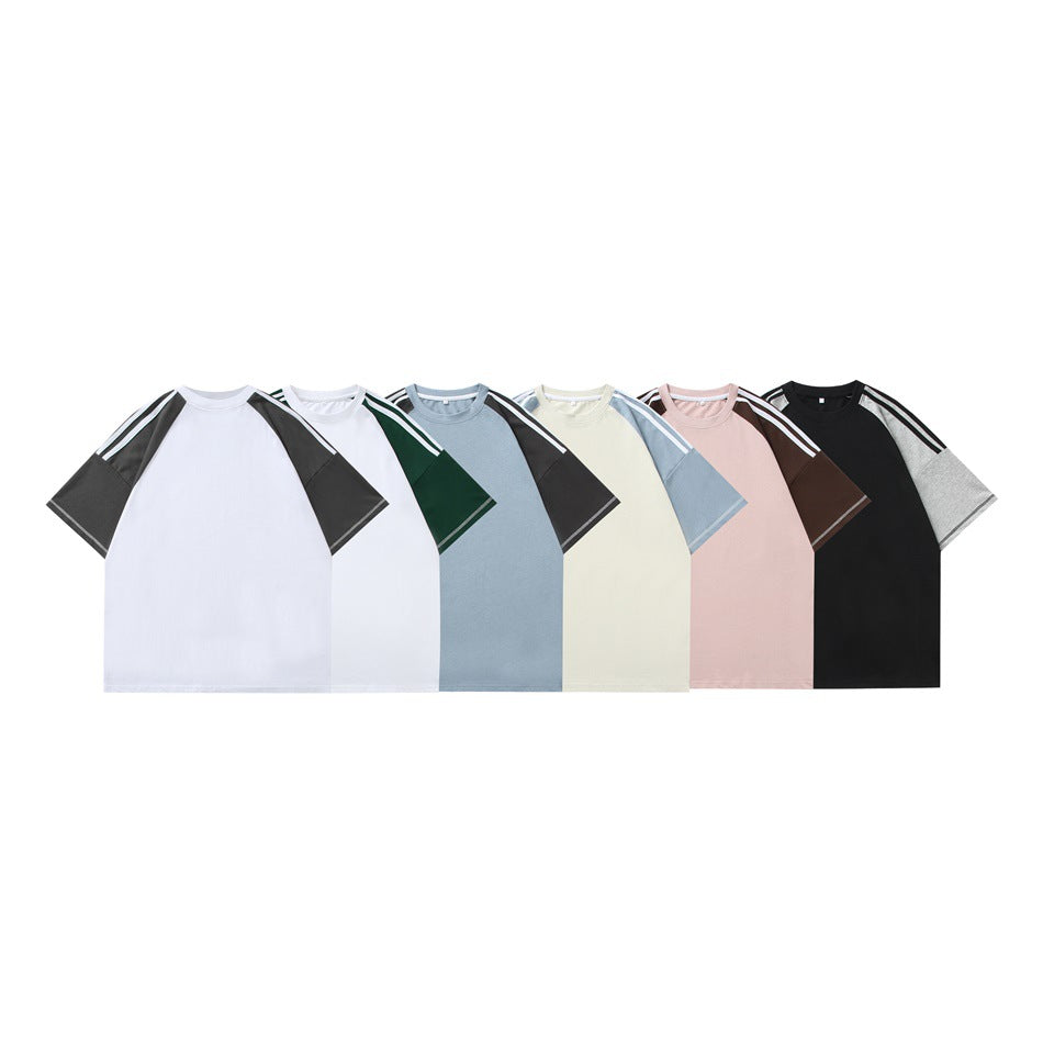 Seven short-sleeve raglan T-shirts displayed front-facing in white, blue, cream, pink, and black colorways.