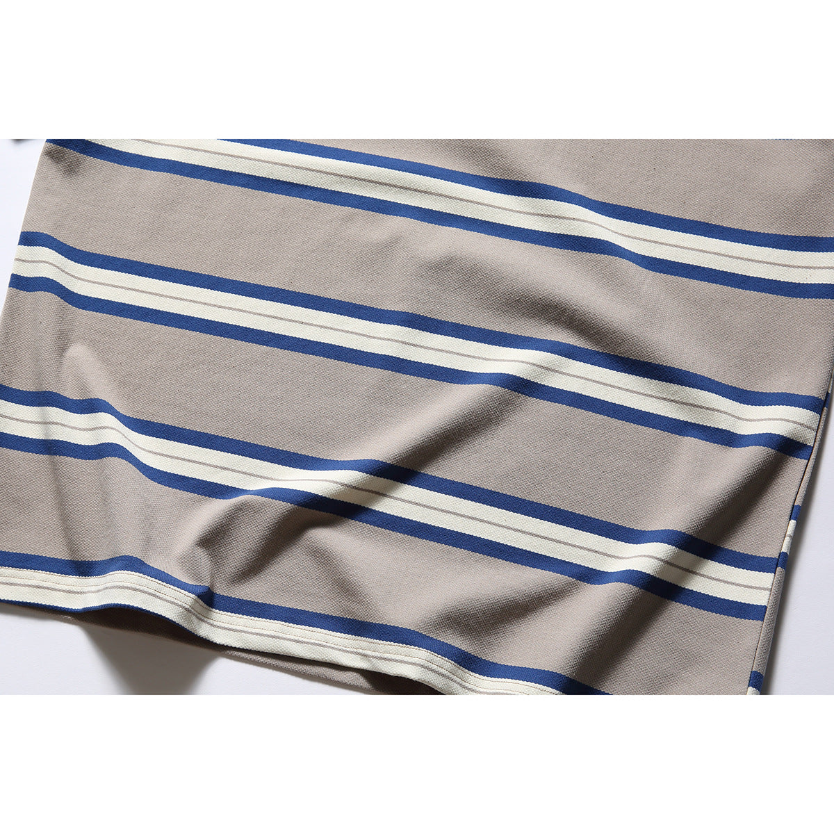Close-up of the taupe T-shirt's blue and ivory stripes and textured fabric.