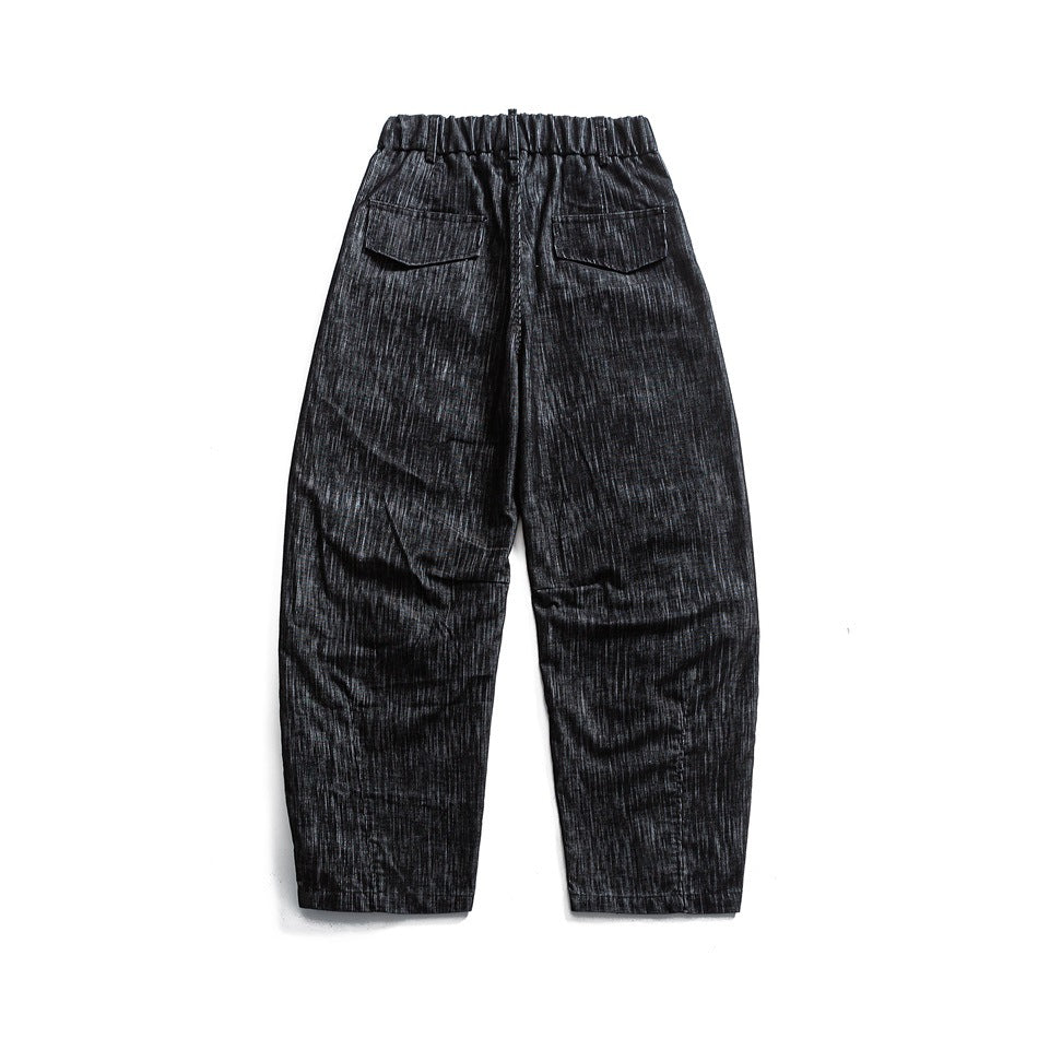 Back view of black-gray textured pants with an elastic waist, two flap pockets, and straight cropped legs.