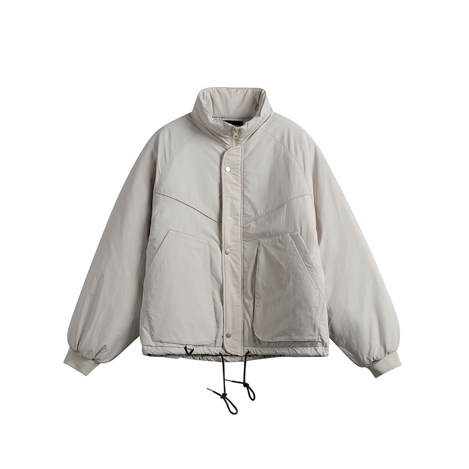 Light gray padded stand-collar jacket, front flat view with snap placket, large patch pockets and drawcord hem