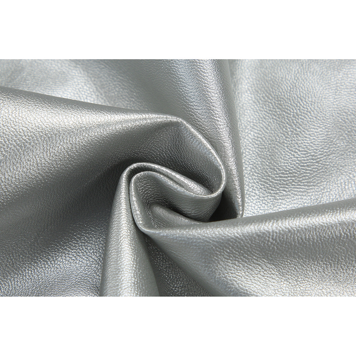 Close-up of textured, metallic silver material folded into soft pleats.
