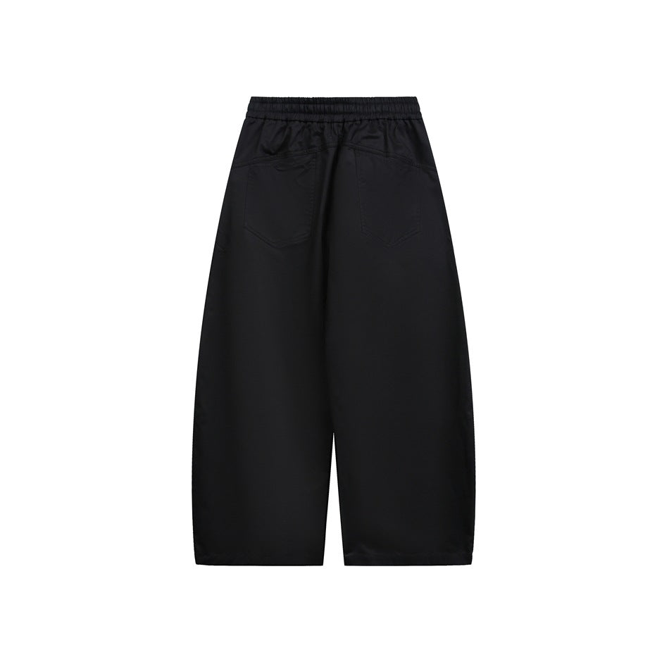 Back view of black wide-leg pants with a gathered elastic waistband and two back pockets.