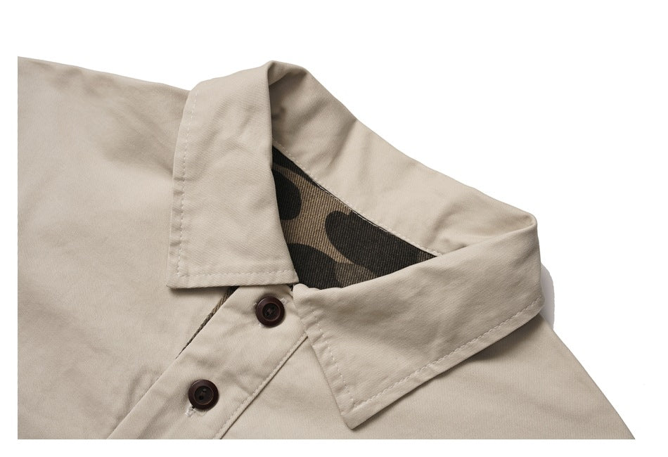 Close-up of the beige jacket's collar, showing camouflage-print inner facing and dark buttons.