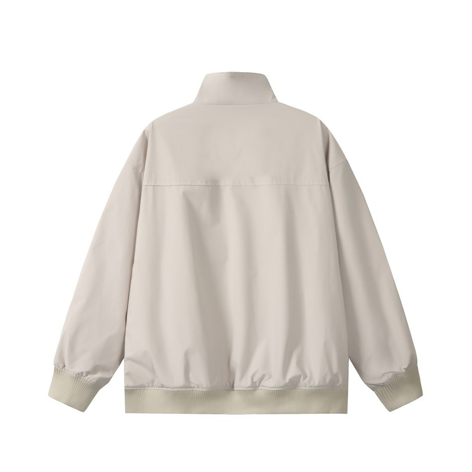 Back view of a light beige jacket with a stand collar, long sleeves, and ribbed cuffs and hem.