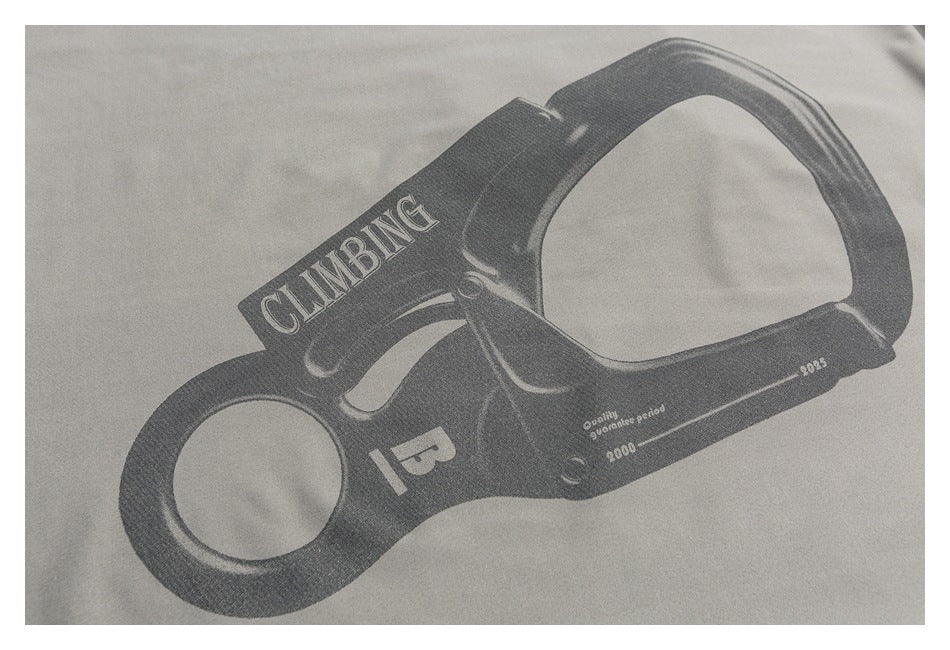 Close-up of a dark climbing-device graphic with English lettering printed on light gray fabric.