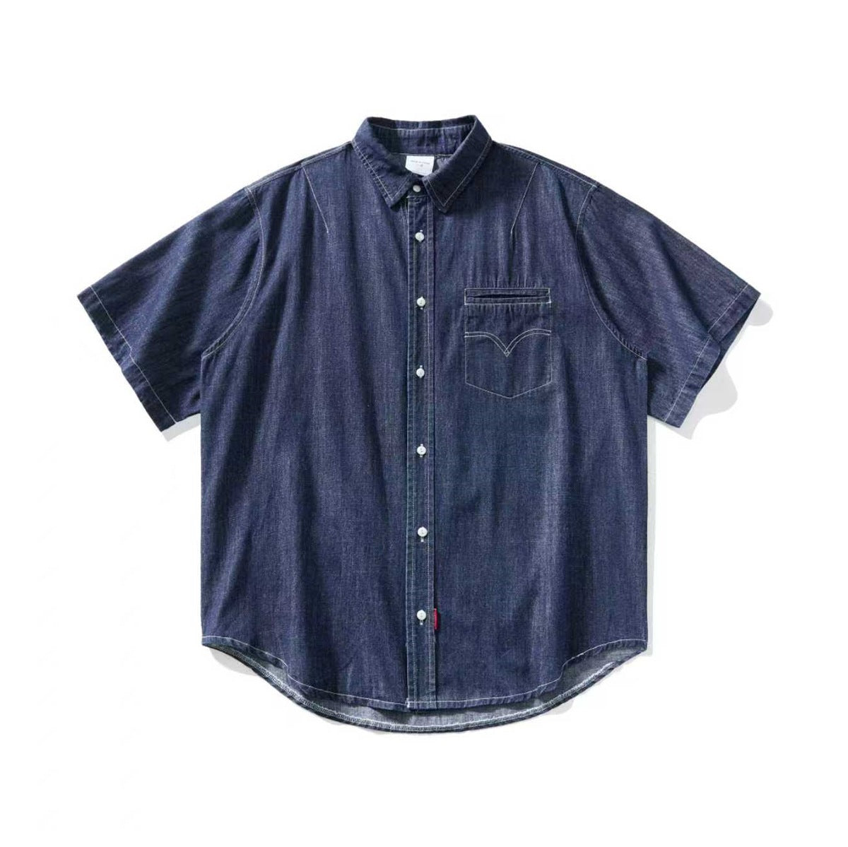 Dark indigo denim short-sleeve button-up shirt laid flat, with chest pocket and curved hem