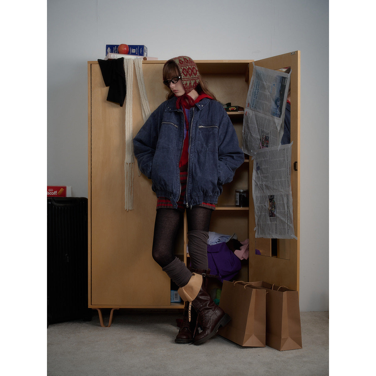 Model wearing an oversized navy washed jacket with a zip front, two zip chest pockets, and elastic cuffs and hem.