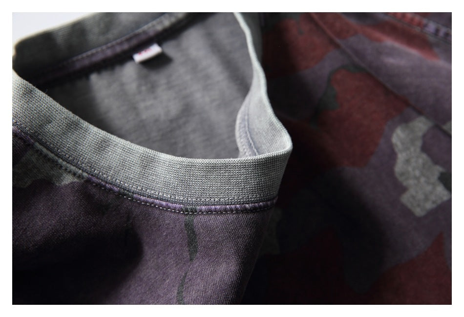 Close-up of a gray ribbed collar on a maroon, gray, and dark camouflage shirt.