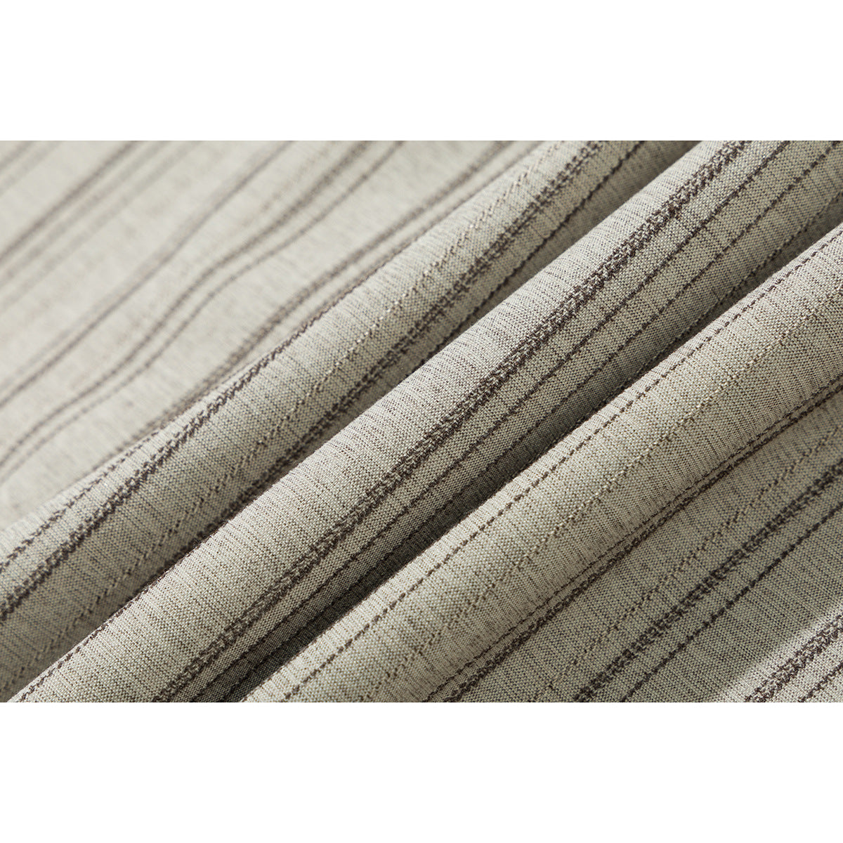 Close-up of the beige shirt's fabric with narrow, irregular dark stripes.