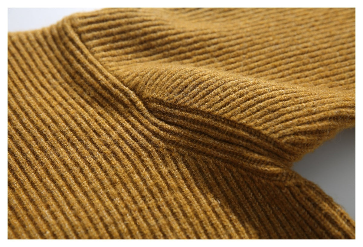Close-up of the ribbed knit cardigan collar and neckline seam in mustard brown.