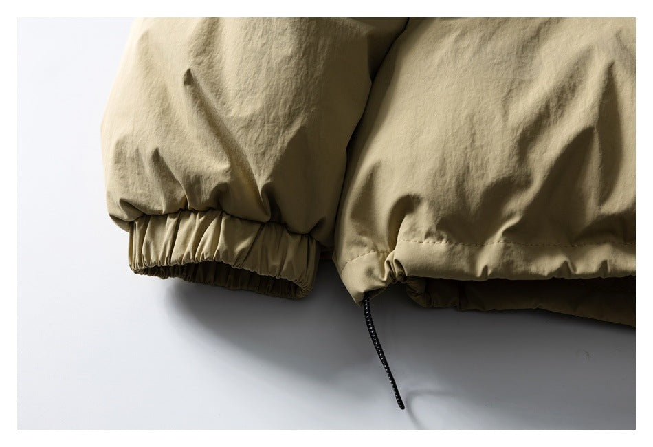 Close-up of a khaki jacket's elasticized cuff and adjustable drawcord hem.
