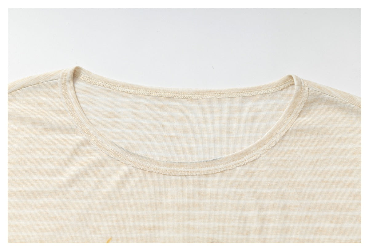 Close-up of the rounded neckline on a light beige T-shirt with subtle horizontal stripes.