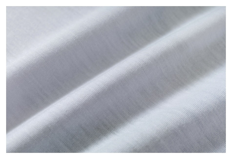 Macro view of light gray-white fabric with a fine, subtle texture and soft folds.