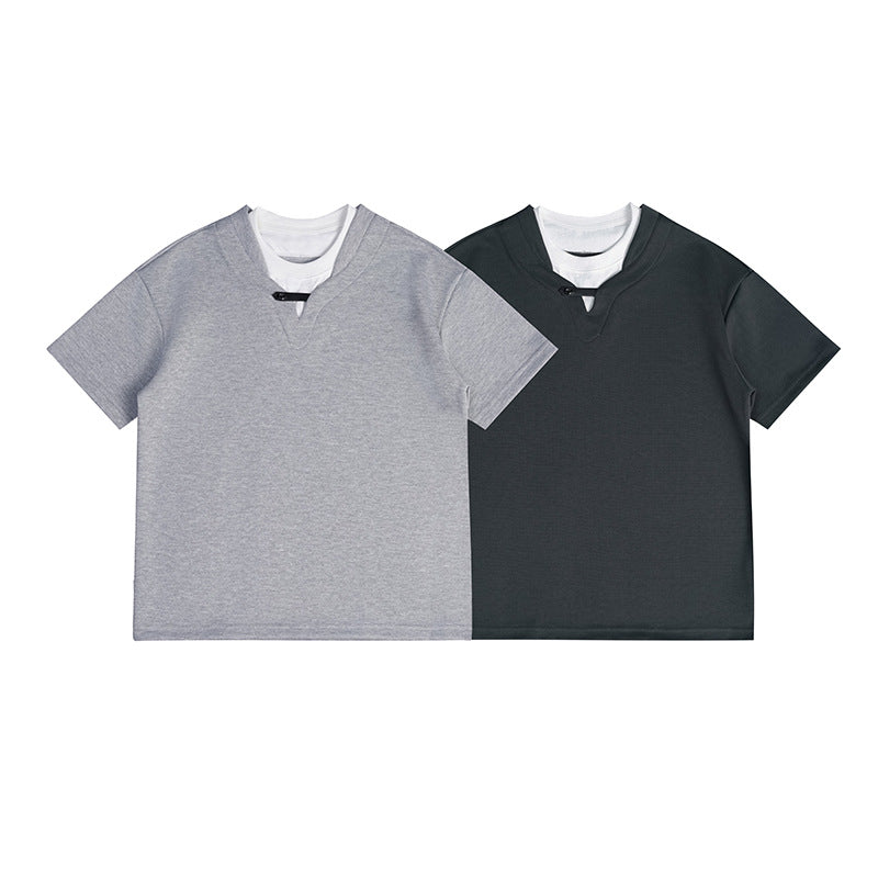 Two short-sleeved V-neck shirts shown from the front: one heather gray and one dark charcoal, each layered over white.