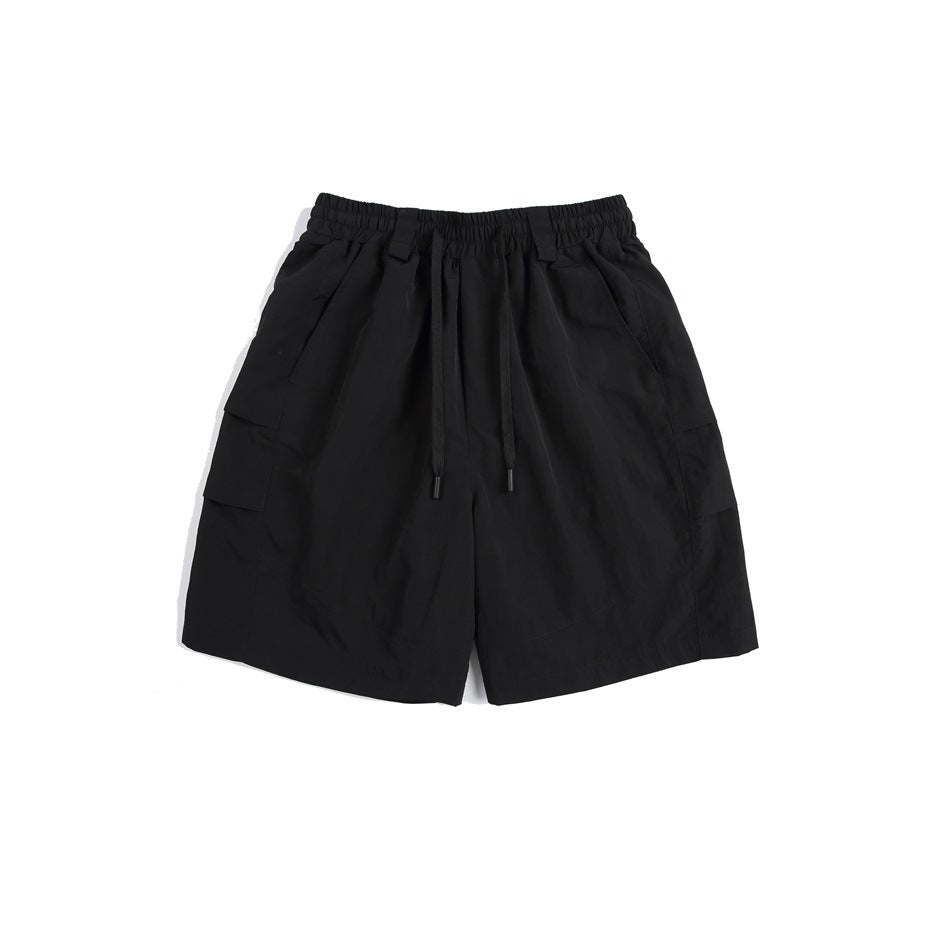 Black knee-length shorts with elastic drawstring waist and side cargo pockets, flat lay front view